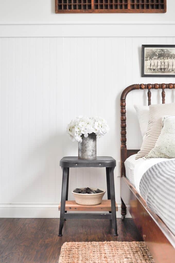 This farmhouse style guest bedroom looks great painted with True White by Magnolia on the bead board paneling and Shiplap by Magnolia painted on the top walls. 
