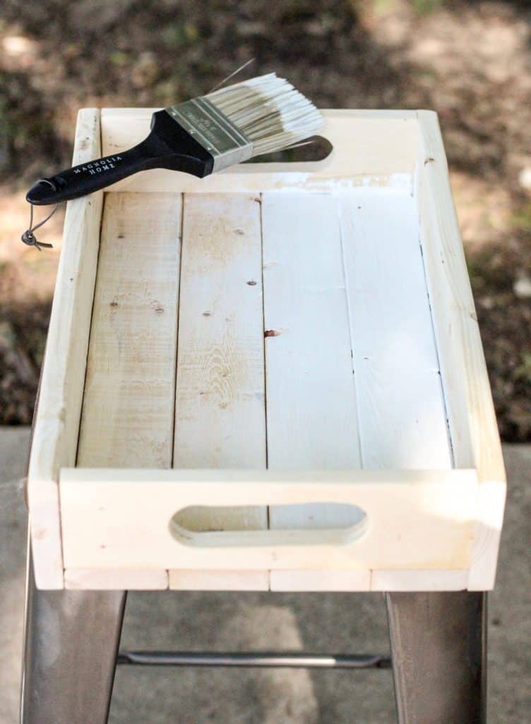 This unfinished wooden crate is getting painted with Shiplap by Magnolia Home, which is a pretty creamy white color that fits right in with the farmhouse style