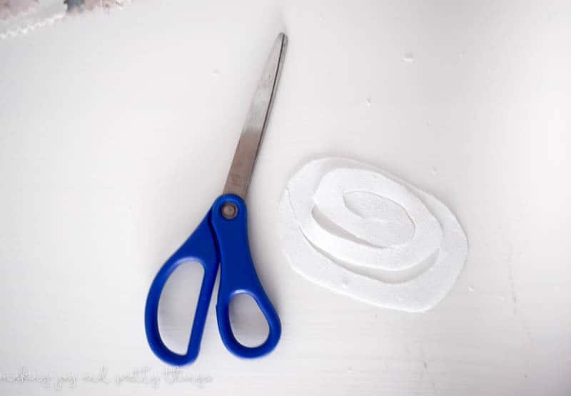 In order to create flowers from an oval fabric you have to cut the oval into a spiral for the fabric to wrap on itself