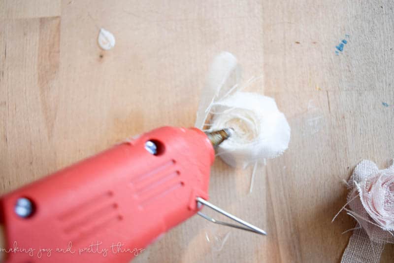 Hot gluing a DIY fabric flower together attach it together using a no sew technique