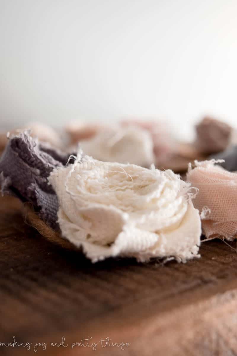 Fabric rosette made into garland sitting on shelf