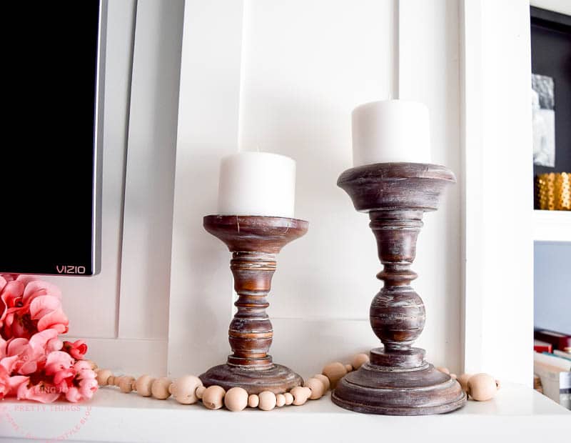 These faux aged candleholders look great styled on a mantel or floating shelves to decorate on a budget 