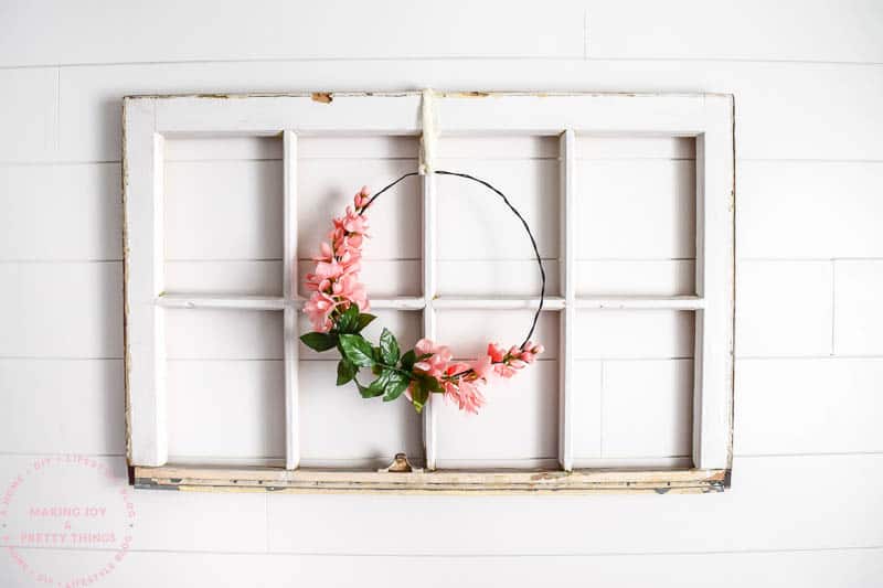 Finished Wreath on a window hung up with lace for a nursery on a shiplap background wall with farmhouse touches