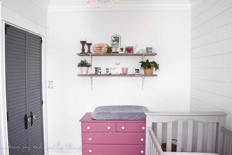 Baby girl nursery reveal in a farmhouse style with shiplap and decorated DIY rustic shelves 