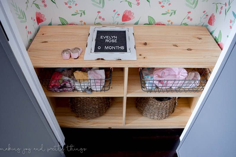 Shelving and open dresser concept made in a closet to add storage with wire baskets, woven baskets, and a top shelf for any pictures