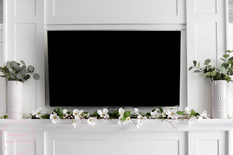 If you need ideas for tv mantle decor trying using a farmhouse spring garland for you mantle