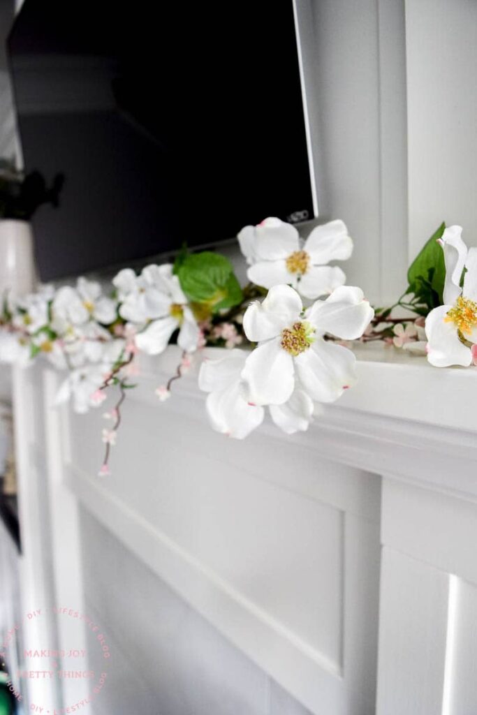 Spring blossoms and magnolia flowers really capture the season in a farmhouse garland on your mantel