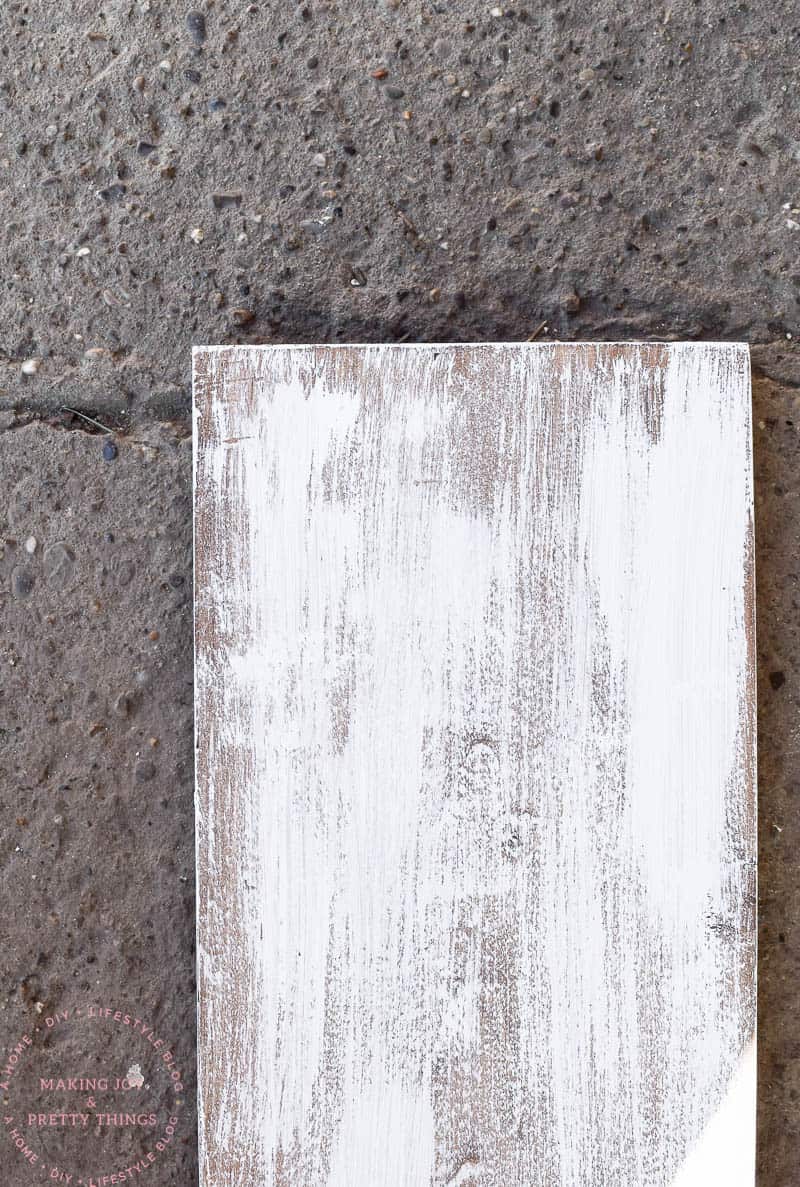 Using new wood to make a distressed farmhouse look is easy when you stain, paint, and sand for the look