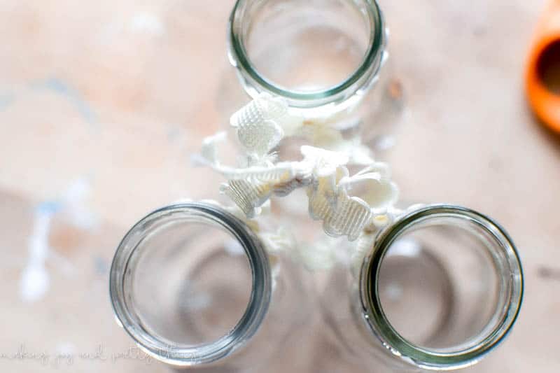 Using a knot to combine multiple jars together to make a hanging decoration with vintage lacy ribbon