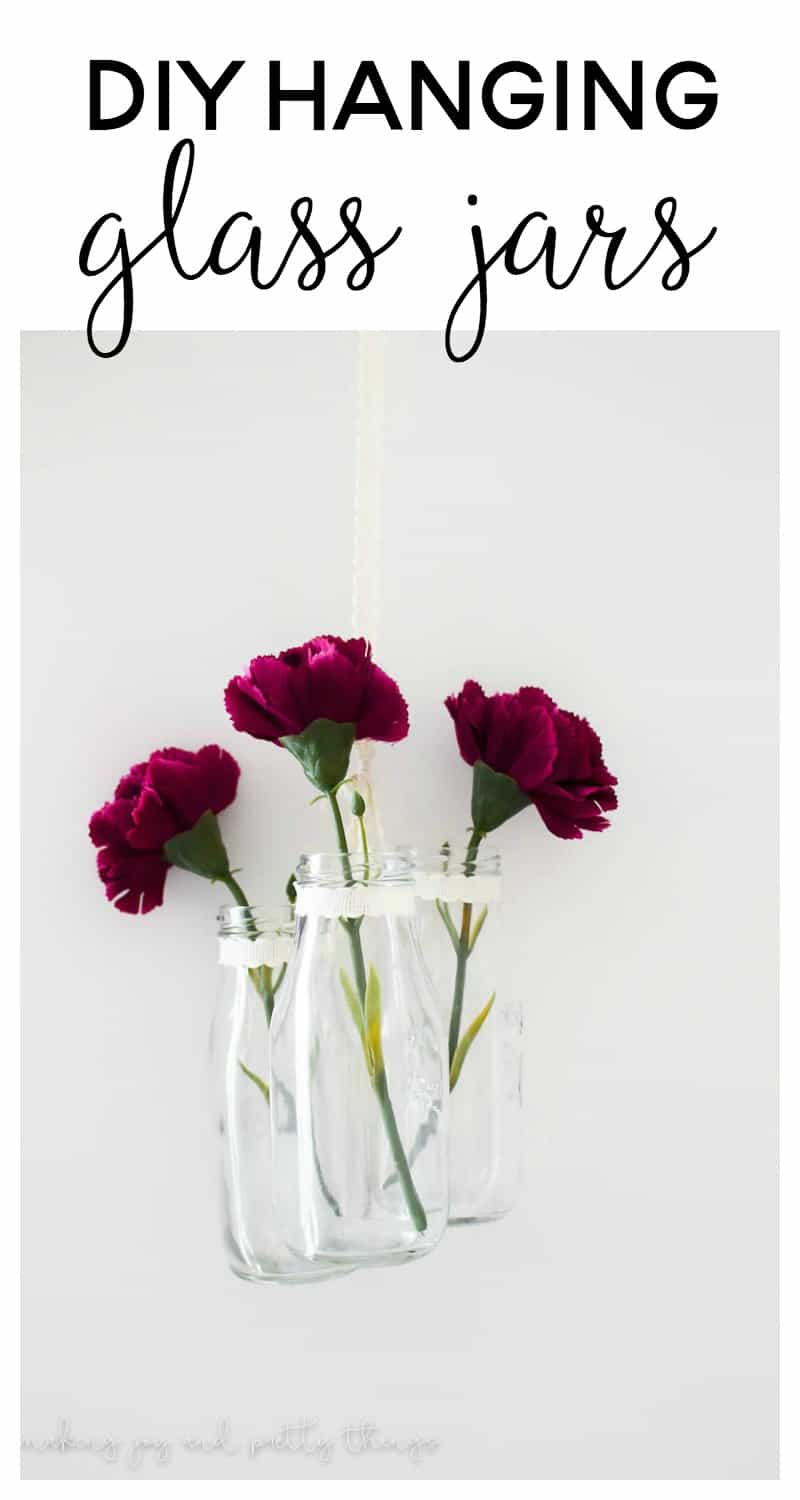 An easy farmhouse style DIY using milk jars and single stem flowers to make DIY hanging glass jars