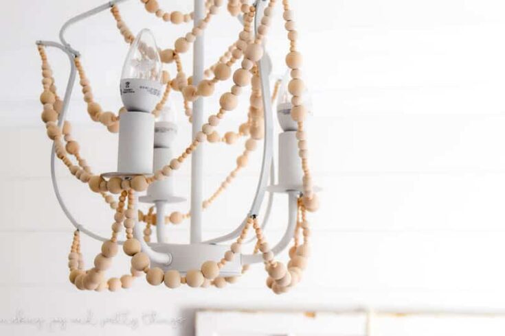 Easy DIY to make a wood bead chandelier! The perfect DIY craft to add farmhouse style to your home.