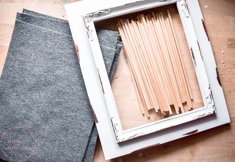 Preparing the frame for a newborn letter board by removing the backing and glass