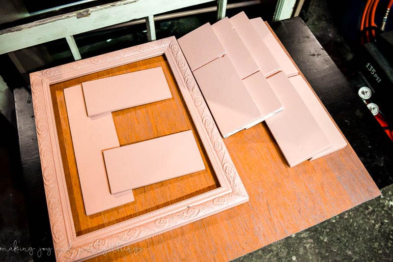 Cut parts for shadowbox ready to be assembled with shelves, a frame paint, sanded and ready to go.