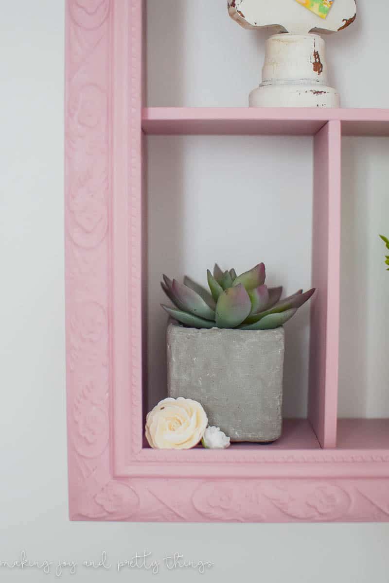 Cute succulent plant inside a compartment built into a DIY shadow box frame