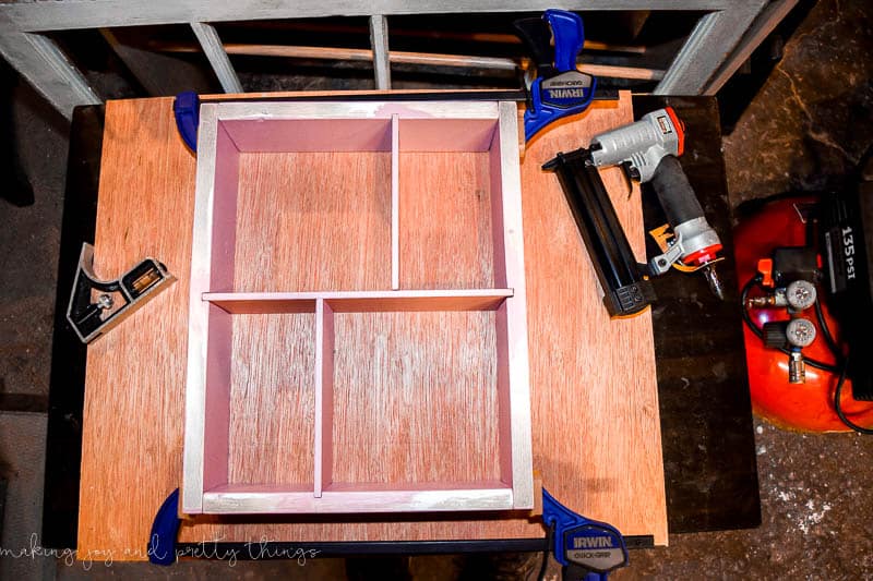 The DIY shadow box shelves and compartments all nailed together and ready for the picture frame border