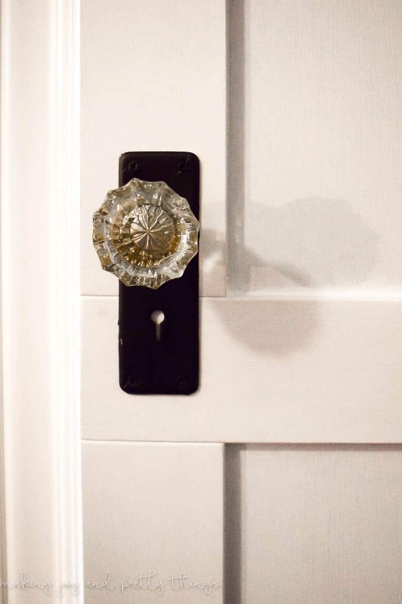A close up look at the antique crystal and brass closet doorknobs installed on our new attic walk-in closet door.