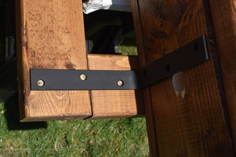 Mark and attach brackets to hold planter box onto an exterior frame for a herb garden