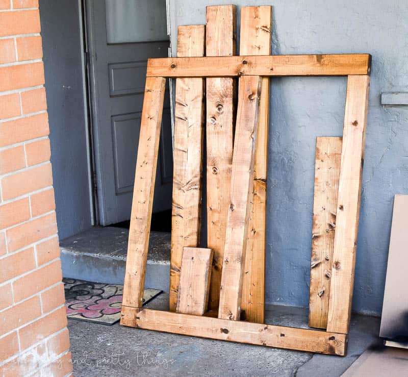 Completed planter frame and other wood pieces all stained to match that will hold plants and provide shelves