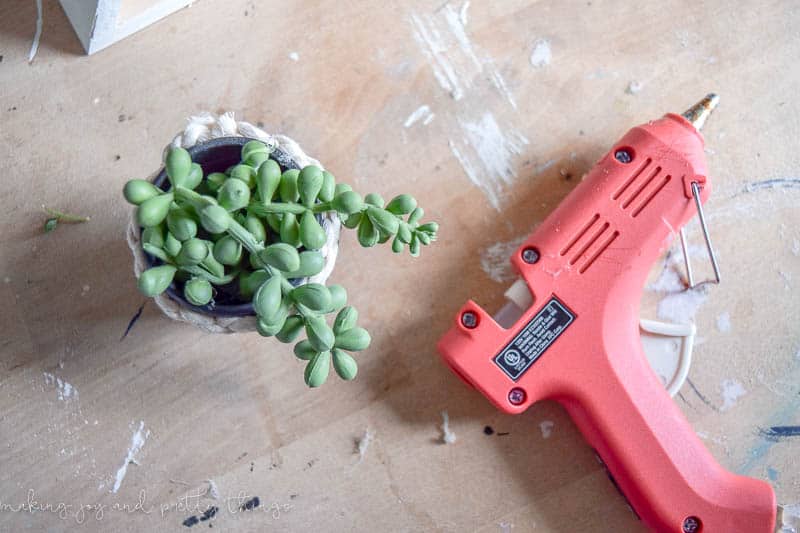 DIY Triangle Shelf Planter using a $3 Dollar Store Shelf and old play-doh container. Dollar store craft | DIY craft | upcycle | planter ideas | succulents