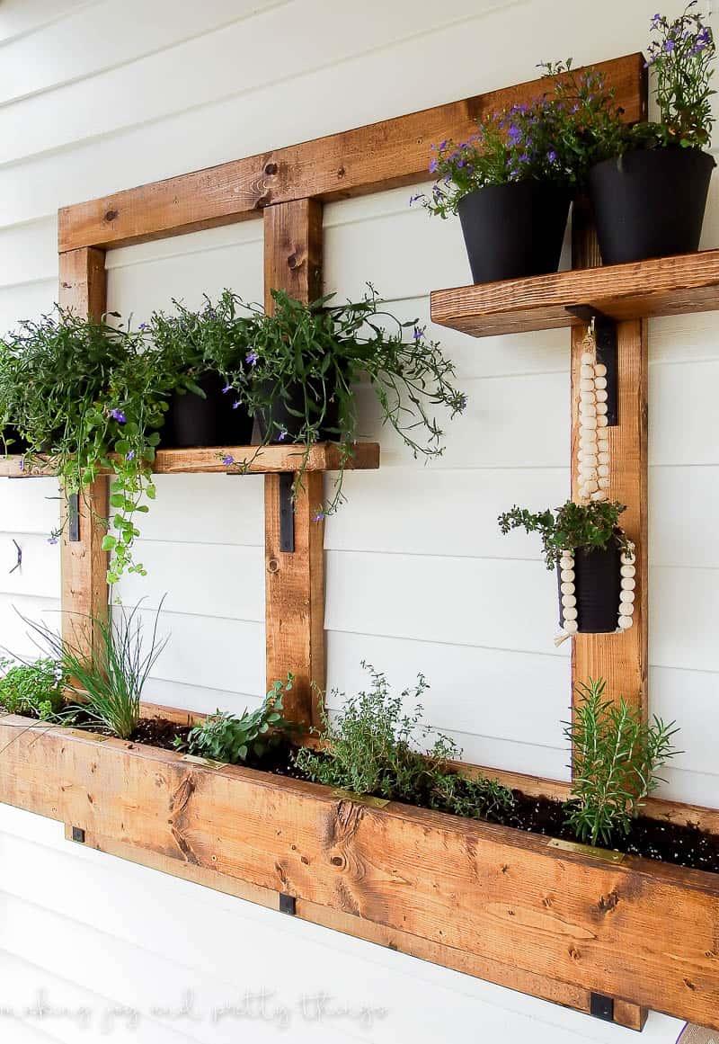 Hanging pots and plants in a planter outside a home hung on siding made with all 2x4's easily