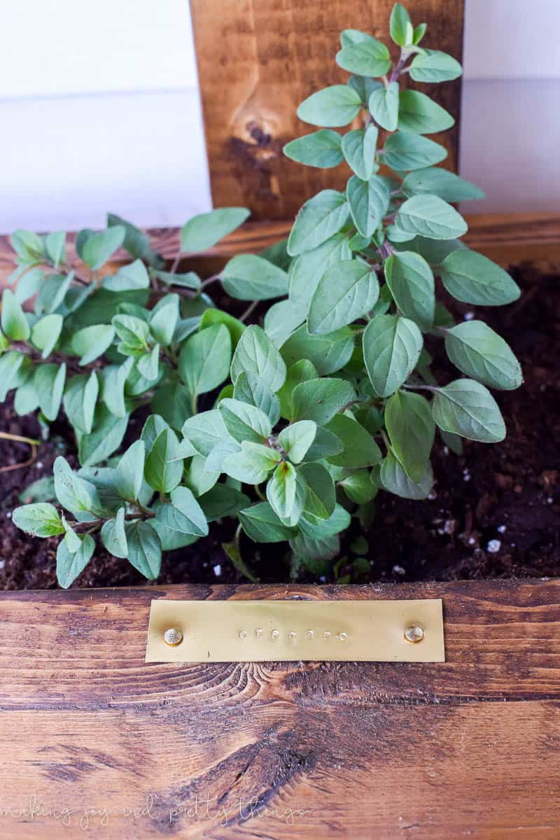 Ad some stamped labels to your DIY vertical herb garden planter box so you know what herbs you have