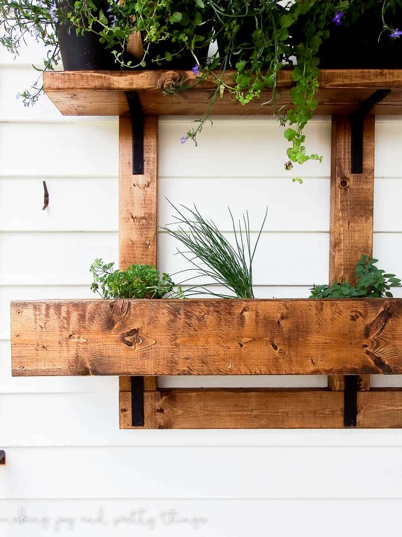 This simple 2x4 planter box diy is easy to get done in a single weekend and is a great idea to ad plants outside