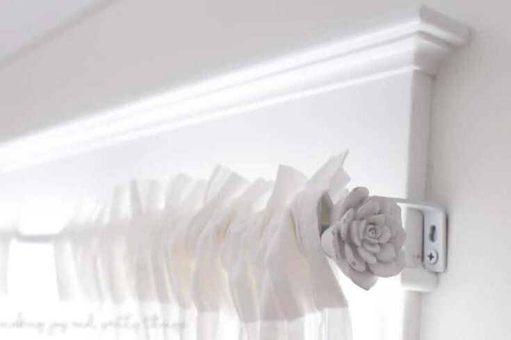 Turn an old curtain rod into a farmhouse style curtain rod. Add some drawer knobs to the ends and you have a budget friendly project!