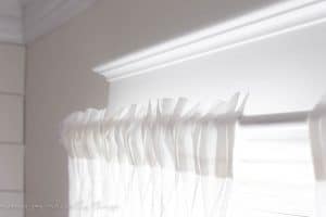 Turn an old curtain rod into a farmhouse style curtain rod. Add some drawer knobs to the ends and you have a budget friendly project!