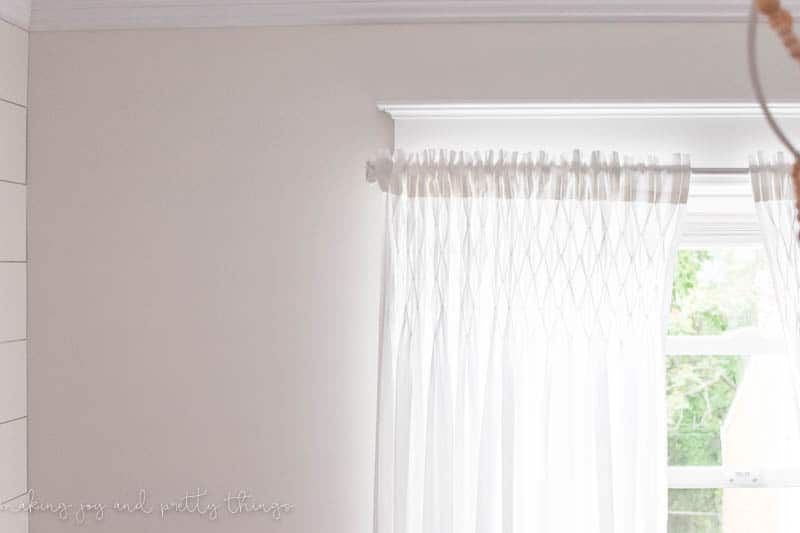 Turn an old curtain rod into a farmhouse style curtain rod. Add some drawer knobs to the ends and you have a budget friendly project!