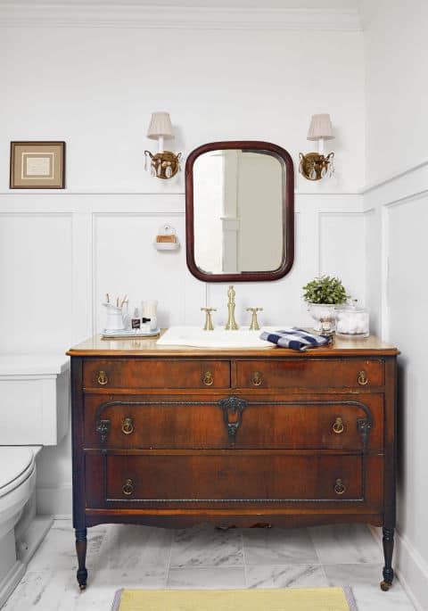 Vintage brown distressed dresser finished in a farmhouse rustic style for a bathroom remodel