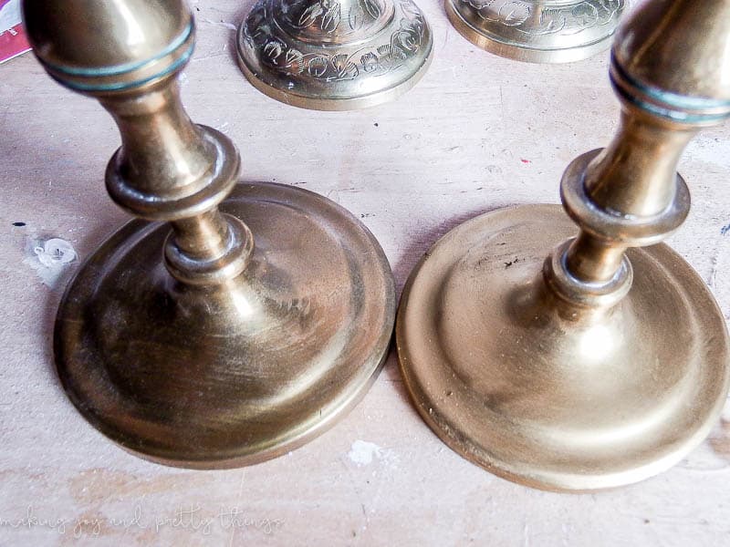 Two candleholders side by side; the base of the candleholder on the left is updated with a golf leaf gilding wax, giving it a bright, shiny finish.