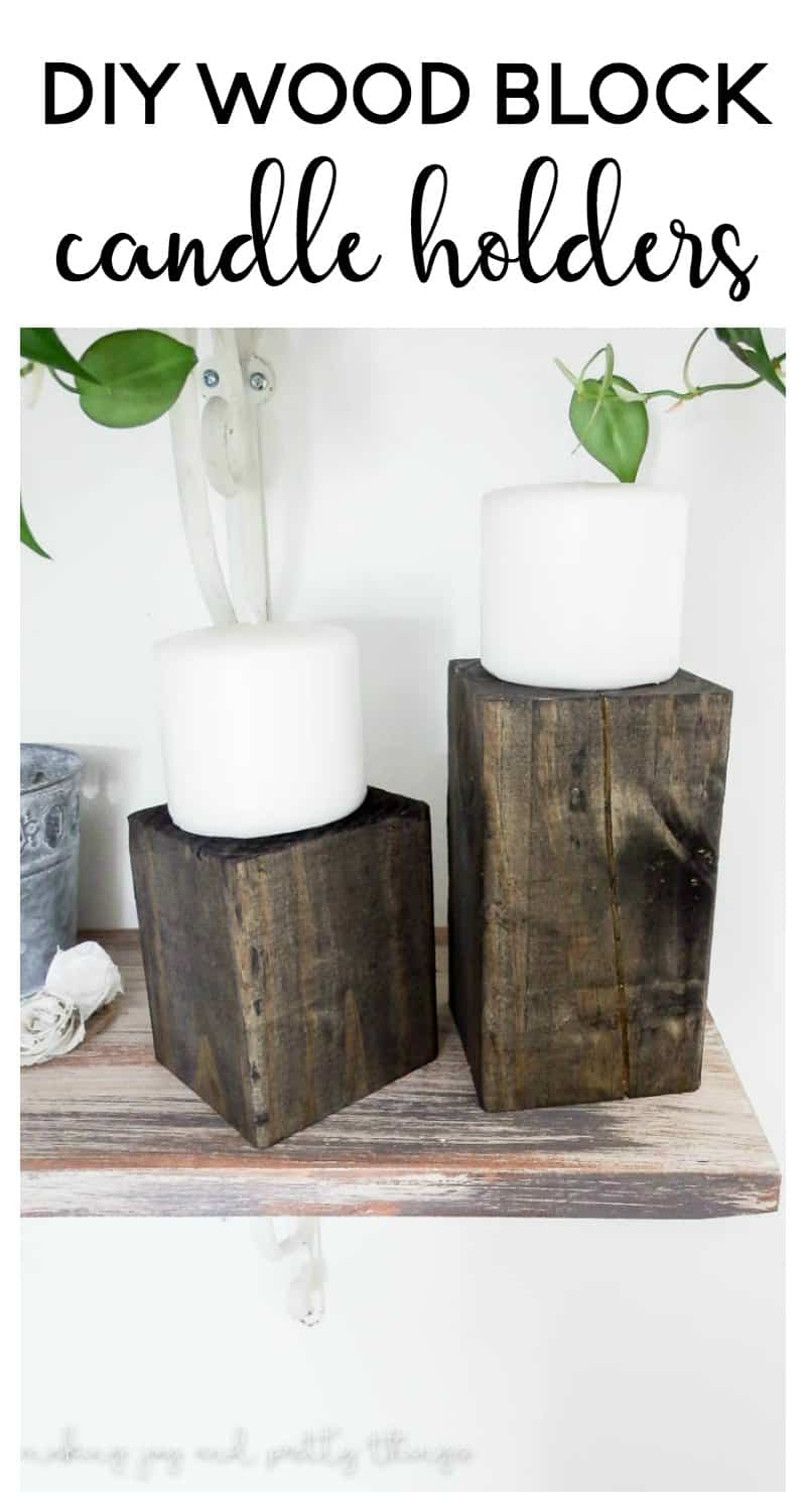 wood block candle holders made with 4x4 fence post sitting on floating shelf with white pillar candles sitting on top with text overlay that says DIY wood block candle holders