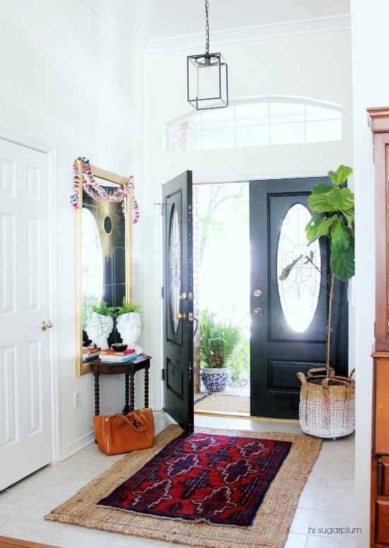 A photo of a Sisal rug with a southwestern patterned vintage rug in the hallway leading to the front door.