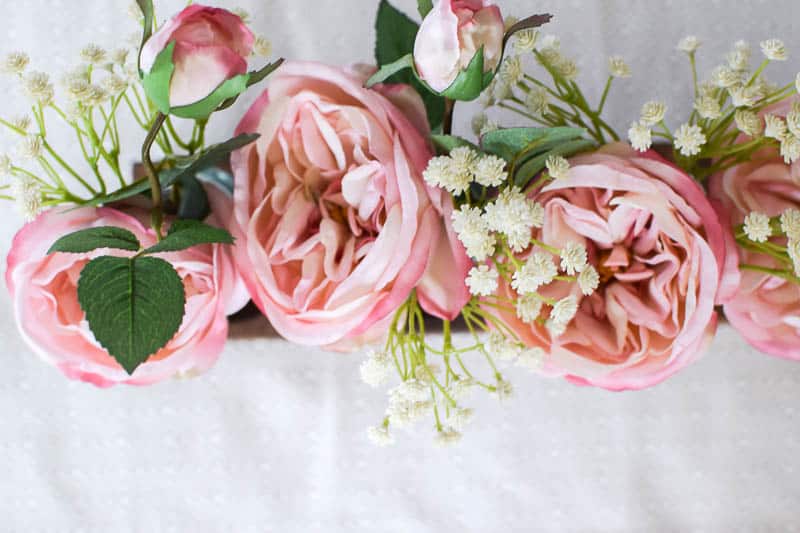 Close up of faux flowers from afloral to create a farmhouse look to a home by making a DIY wood centerpiece