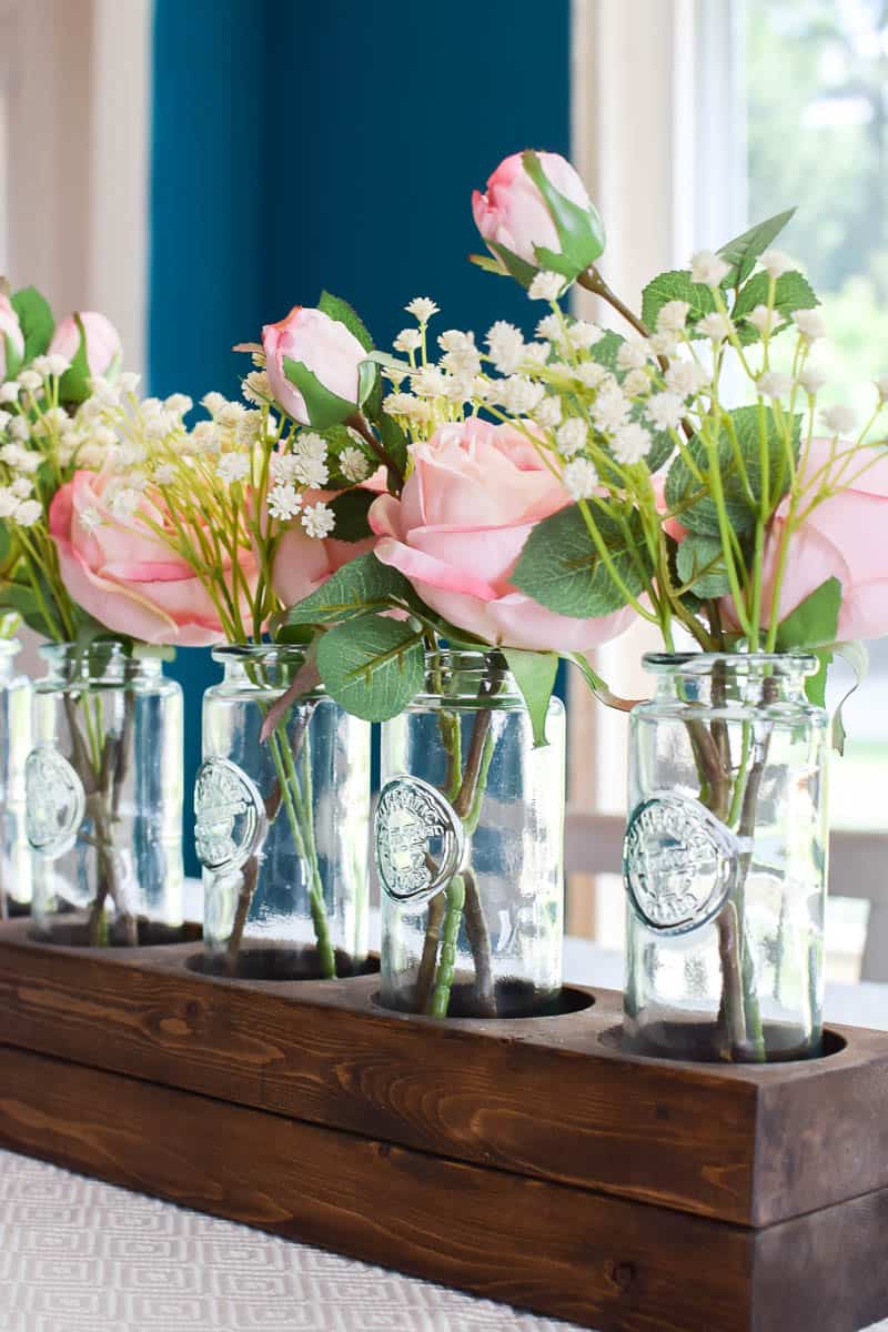 The options for bottles are endless but a clear bottle shows off the greenery and floral used