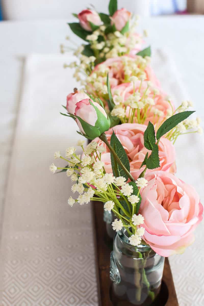 Any style of centerpiece can be made with glass bottles and flowers but a farmhouse style really works well with just about any space