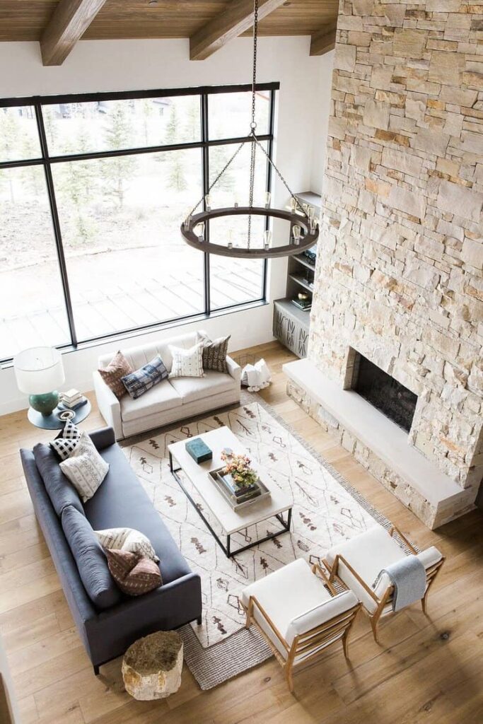 A neutral patterned rug is layered over a jute sisal rug in the living room, creating an interesting texture.