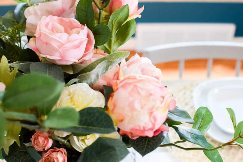 Close up of flowers that are pink and shades of white with other greenery inside