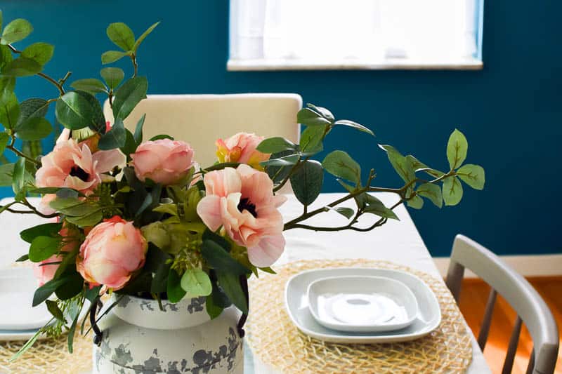 You can use rustic farmhouse flower arrangements in a lot of different ways like this one as a dining table center piece