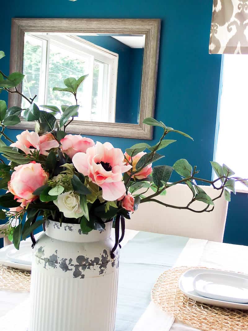 Farmhouse flower arrangement inside an old vintage milk vase that is a great idea to add rustic decor to your home