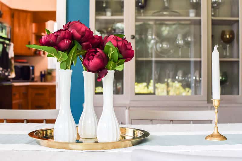 See how I used thrift store vases and just one type of flower to make the prettiest centerpiece perfect for Fall!