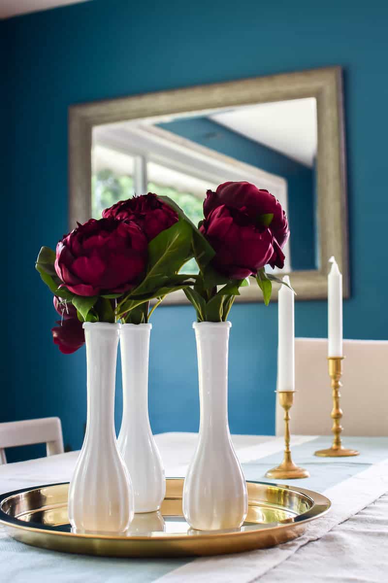Beautiful thrifted vases and restored candlestick holders make a great table scape when you add a simple floral centerpiece