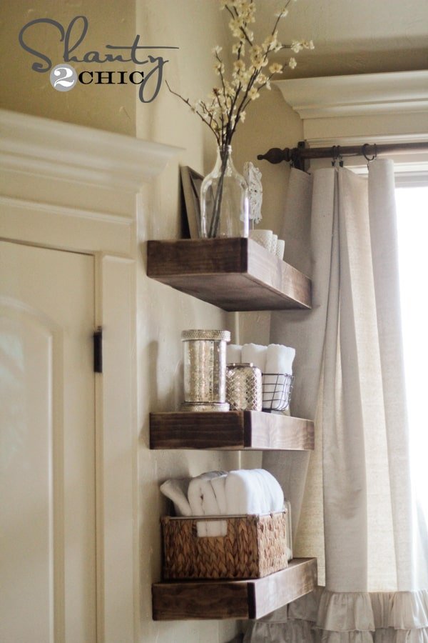 DIY floating shelves in a bathroom as part of a remodel to give rustic touches and save money 