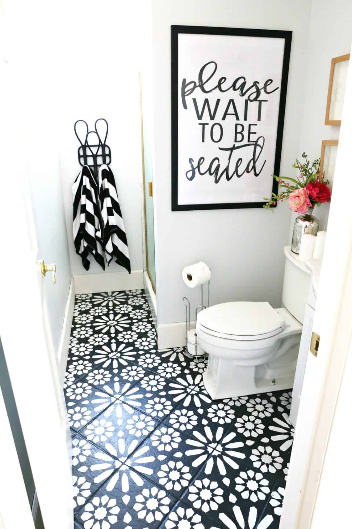 Black and white stenciled tile used in a bathroom remodel as a way to save money on a renovation