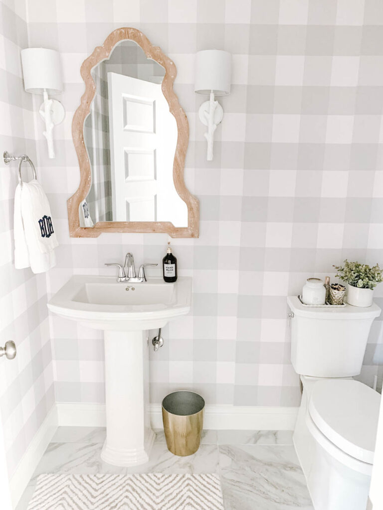 Farmhouse chic powder room with buffalo check plaid wallpaper on the walls