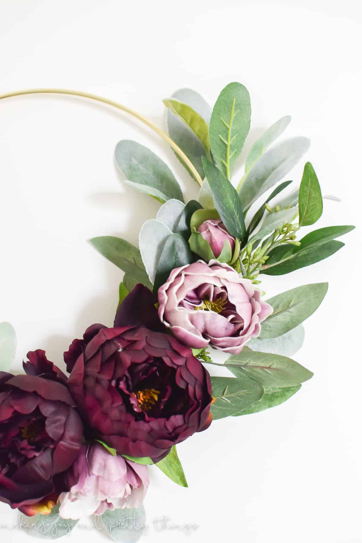 Close up look at flowers in the DIY gold ring wreath attached using floral wire