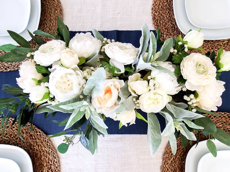 Overhead view of the DIY wooden box centerpiece finished and full of greenery and flowers