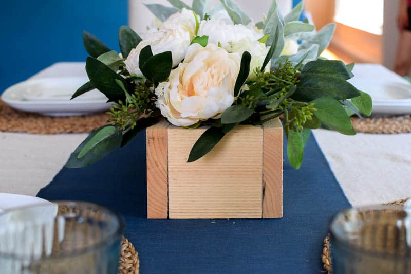 A beautiful farmhouse floral arrangement is an easy to do and fun project to really add some color to a dining room table 