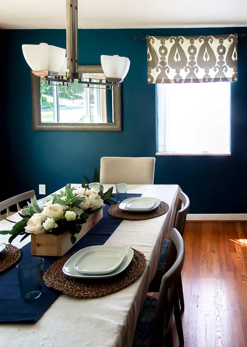 Farmhouse flower centerpiece in a home with accents on a dining room table 