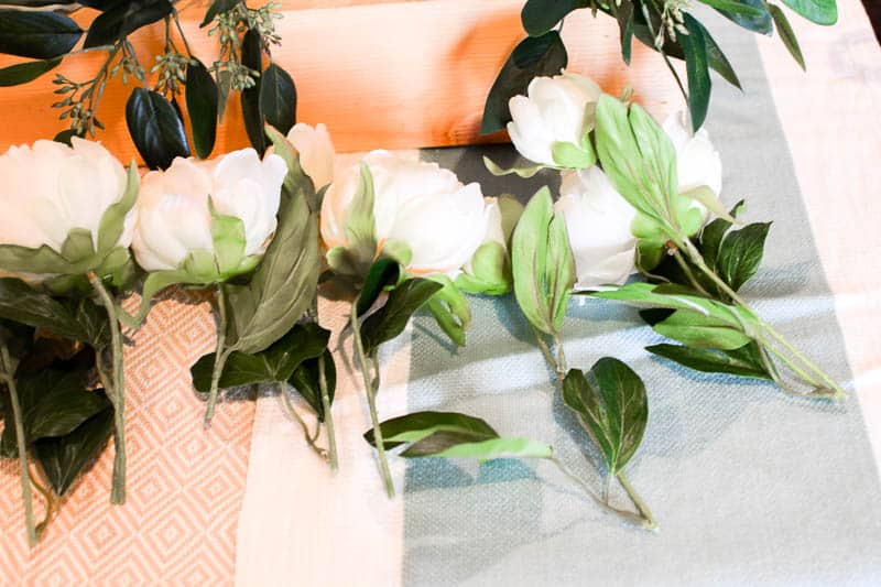 Lay out flowers to see how to install them into the floral foam for the DIY wooden box centerpiece to make sure your decor is balanced